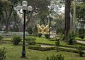 Lampoles, manicured lawn and ceramic water fountain with golden lotus flower , Hanoi, Vietnam