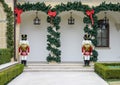 Two nutcrackers guarding the steps at the end of the front sidewalk to an expensive home in Dallas, Texas