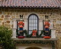 Two Nutcrackers guarding the door of a balcony on the second floor of a mansion in Highland Park at Christmas, Texas