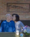 Old love birds on Mother`s Day, an appreciative kiss for gifts given