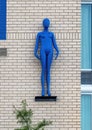 Blue three dimensional figure decorating the side of a building in Dallas, Texas.
