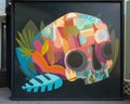 Colorful half-skull mural by Jaime Molina and Pedro Barrios outside a restaurant in Vail Village, Colorado.