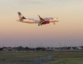 Volaris Airlines jet landing in the evening at Love Field in Dallas, Texas.