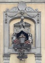 Wall art with cherubs surrounding a gothic lamp in Florence, Italy.