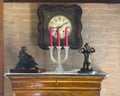 Wall clock, candelabra, and two small statues in the tasting room of Acetaia Dei Bago in Modena. Royalty Free Stock Photo