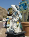 Weathered cool shark statue and large pots with cacti along the dock in Cabo San Lucas.