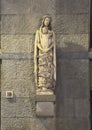 Sculpture Mary holding infant Jesus with a pile of cherubs in front of her legs in Florence, Italy.