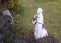 Statue of a girl adoring Mary outside Saint Benedict`s Painted Church on the Big Island, Hawaii. Royalty Free Stock Photo