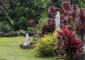 Statue of Mary being adored outside Saint Benedict`s Painted Church on the Big Island, Hawaii. Royalty Free Stock Photo