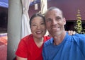 47 year-old Caucasian husband and his 57 year-old Korean wife on restaurant patio in Todos Santos, Mexico.