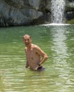 47 year-old Caucasian male tourist enjoying the pool at the bottom of the waterfall at Canyon of the Fox.