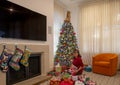 64 year-old Korean mother about to unwrap a Christmas present on Christmas morning in her home in Dallas, Texas.