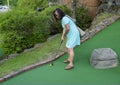 64 year-old Korean woman playing miniature golf on a family vacation in Bar Harbor, Maine. Royalty Free Stock Photo