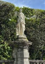 Zephyrus, one of 12 statues of mythical divinities and allegorical figures on the front of the Italian garden of Villa Carlotta. Royalty Free Stock Photo