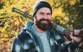 Pictures for Barbershop. Bearded hunter man holding gun and smile. Hunter with long beard on hunt. Barbershop vintage