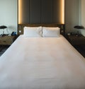 Pictures of a generic hotel room - Bed, window, table, lamps all in shot. Royalty Free Stock Photo
