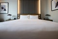 Pictures of a generic hotel room - Bed, window, table, lamps all in shot. Royalty Free Stock Photo