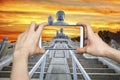 pictures on mobile smart phone in Front View of Tian Tan Giant Buddha in golden sky