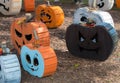 Pictures of various pumpkin carved faces on wood themed pumpkin.