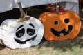 Pictures of various pumpkin carved faces on wood themed pumpkin.