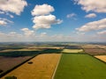 Picturesque aerial view of farmland in the countryside, blue sky with white clouds, colorful fields with different planted crops, Royalty Free Stock Photo