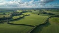 Picturesque aerial view of green rural fields hedgerows sunlit clouds Royalty Free Stock Photo