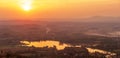 Aerial view of lake with the sun setting over a mountain range Royalty Free Stock Photo