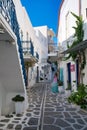 Picturesque alleyway featuring blue balconies of white buildings. Parikia, Paros, Greece.
