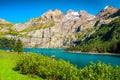 Picturesque alpine lake with high mountains and glaciers, Oeschinensee, Switzerland