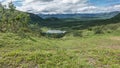 A picturesque alpine lake.  A mountain range against a background of blue sky and clouds Royalty Free Stock Photo