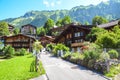 Picturesque Alpine village Wengen in Switzerland in summer season. Mountain chalets, hikers and green hilly landscape. Swiss Alps Royalty Free Stock Photo