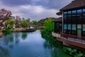 Picturesque arched bridge spanning a tranquil body of water on a cloudy day in Shanghai, China