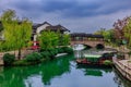 Picturesque arched bridge spanning a tranquil body of water on a cloudy day in Shanghai, China