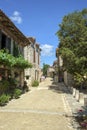 Picturesque architecture and early summer sunshine brings a few visitors to Pujols, Lot-et-Garonne, France