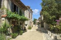 Picturesque architecture and early summer sunshine brings a few visitors to Pujols, Lot-et-Garonne, France