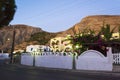 Street view Kamari village Mesa Vouno mountain at dawn Santorini Greece Royalty Free Stock Photo