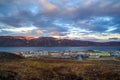 A small northern port town located in the tundra among the mountains on the shore of a sea bay