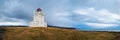 Picturesque autumn evening view to Dyrholaey lighthouse and Reynisfjara ocean black volcanic sand beach in far, Vik, South Iceland