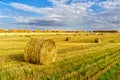 Picturesque autumn landscape with beveled field and straw bales. Royalty Free Stock Photo