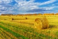 Picturesque autumn landscape with beveled field and straw bales. Royalty Free Stock Photo