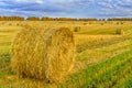 Picturesque autumn landscape with beveled field and straw bales. Royalty Free Stock Photo