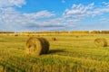 Picturesque autumn landscape with beveled field and straw bales. Royalty Free Stock Photo