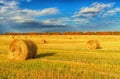 Picturesque autumn landscape with beveled field and straw bales. Royalty Free Stock Photo