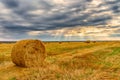 Picturesque autumn landscape with beveled field and straw bales. Royalty Free Stock Photo