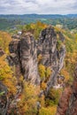 Picturesque autumn scenery with sandstone rocks and colorful trees, Saxon Switzerland, Germany