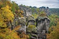 Picturesque autumn scenery with sandstone rocks and colorful trees, Saxon Switzerland, Germany