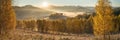 Picturesque autumn view, sunrise. Morning fog over a mountain valley, golden autumn. Panoramic Royalty Free Stock Photo