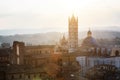 Picturesque backlit view of Siena Cathedral Santa Maria Assunta (Duomo) from Torre del Mangia tower at sunset golden hour, Tuscany Royalty Free Stock Photo