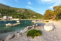 Picturesque bay with moored boats, beautiful blue sea and green trees growing on the hill in the background Royalty Free Stock Photo