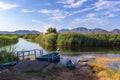 Picturesque bay with moored boats, beautiful blue sea and green trees growing on the hill in the background Royalty Free Stock Photo